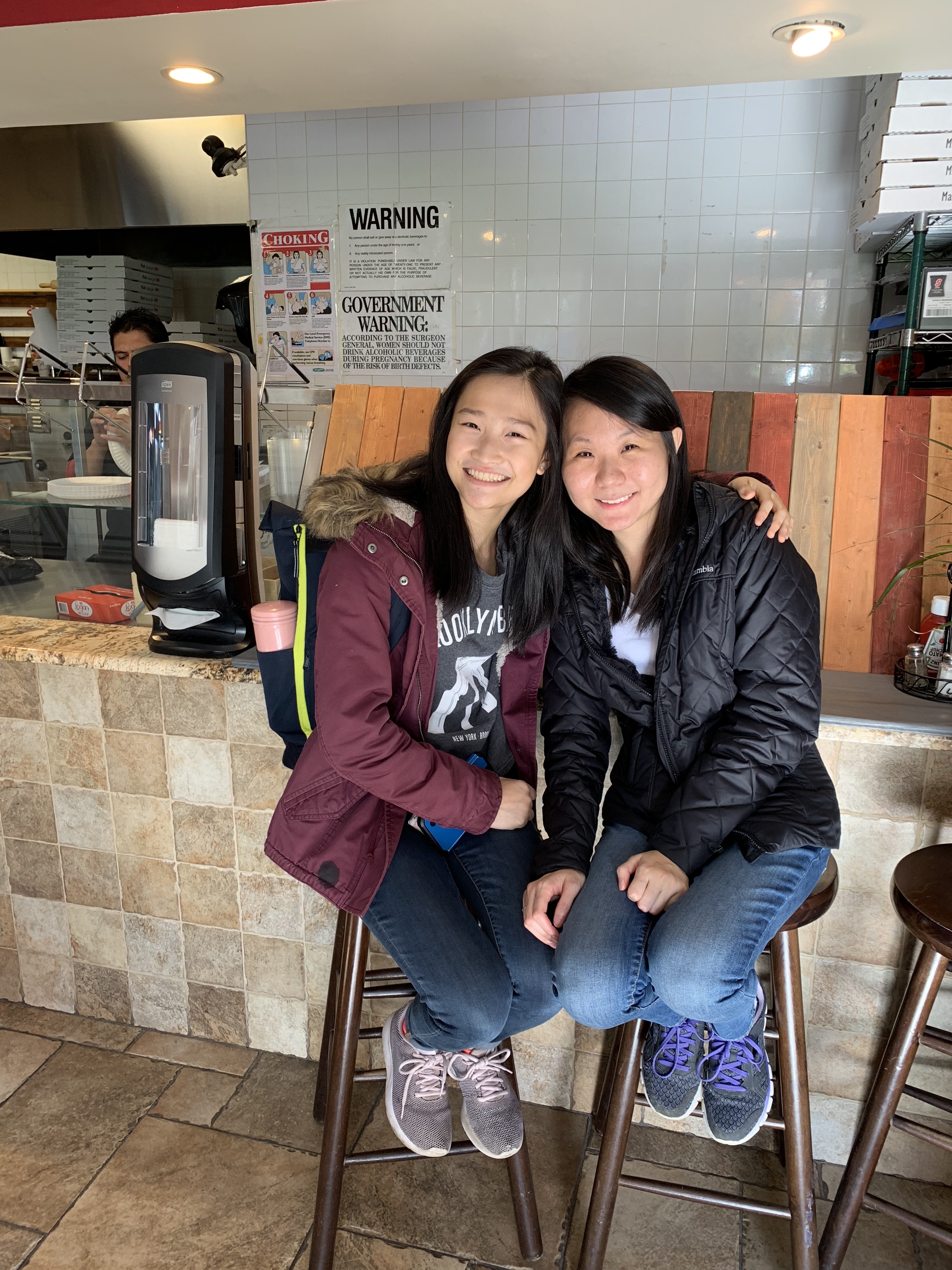 Two beautiful young girls in a pizza resturant.